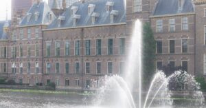 Scenic view of the Binnenhof government complex and water fountain in The Hague, Netherlands.