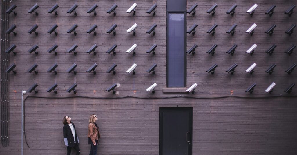 Women observing a wall covered with numerous security cameras in an urban setting, showcasing modern surveillance.